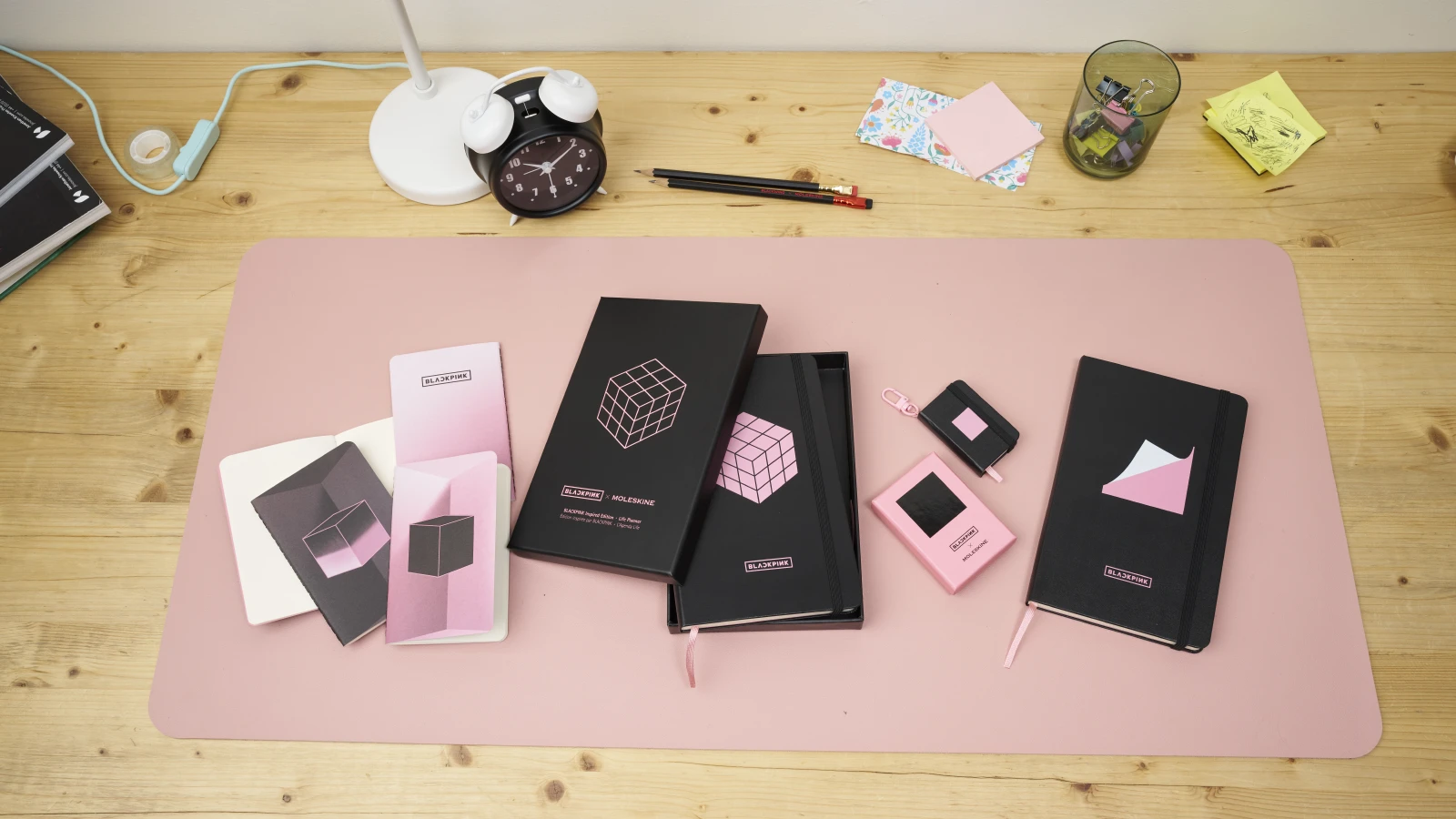 Moleskine x BLACKPINK collection laid out on a pink desk